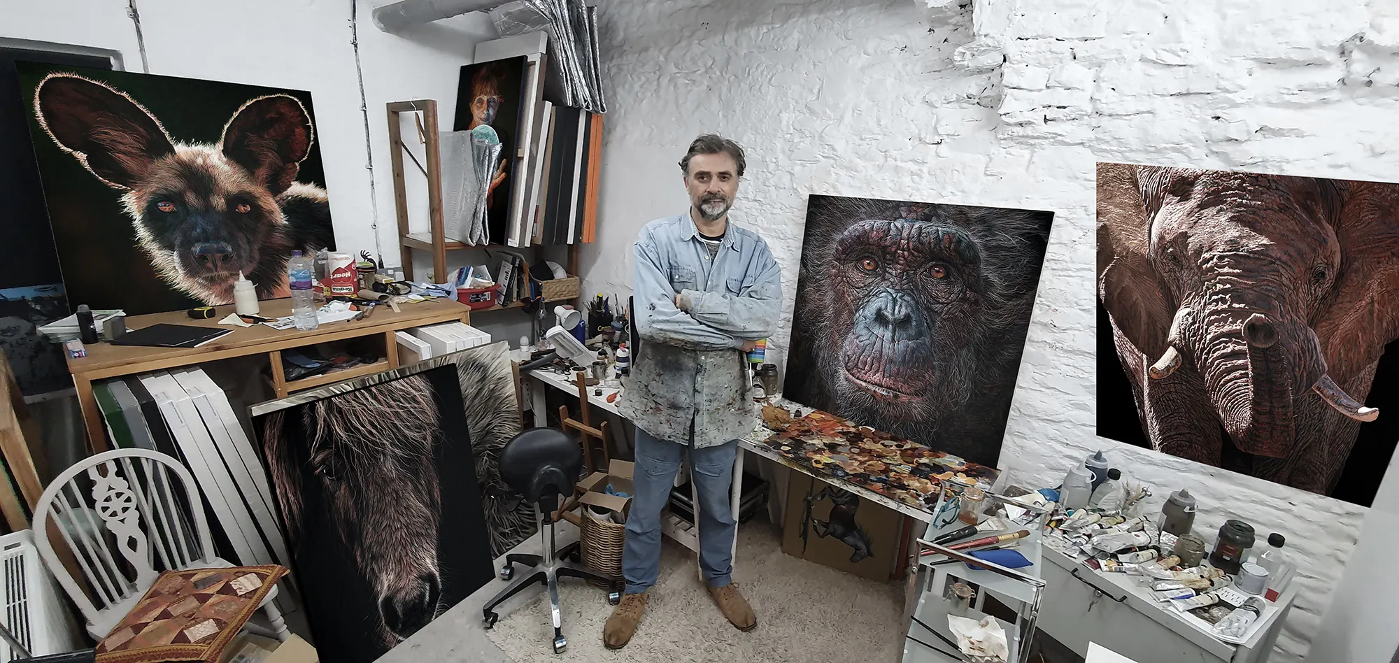 Steve Nayar in his busy painting studio surrounded by finished canvases and tools of the trade
